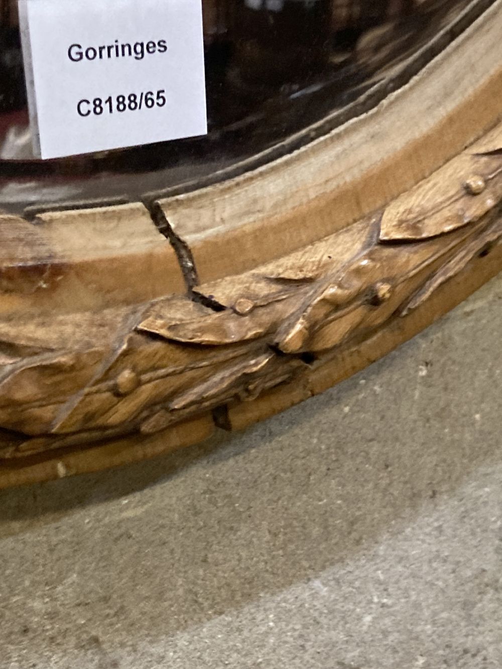An oval laurel carved mirror, width 64cm height 75cm